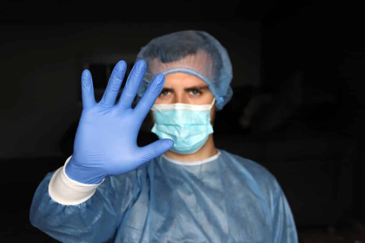 person-in-blue-long-sleeve-shirt-covering-face-with-hand-stockpack-unsplash person in blue long sleeve shirt covering face with hand