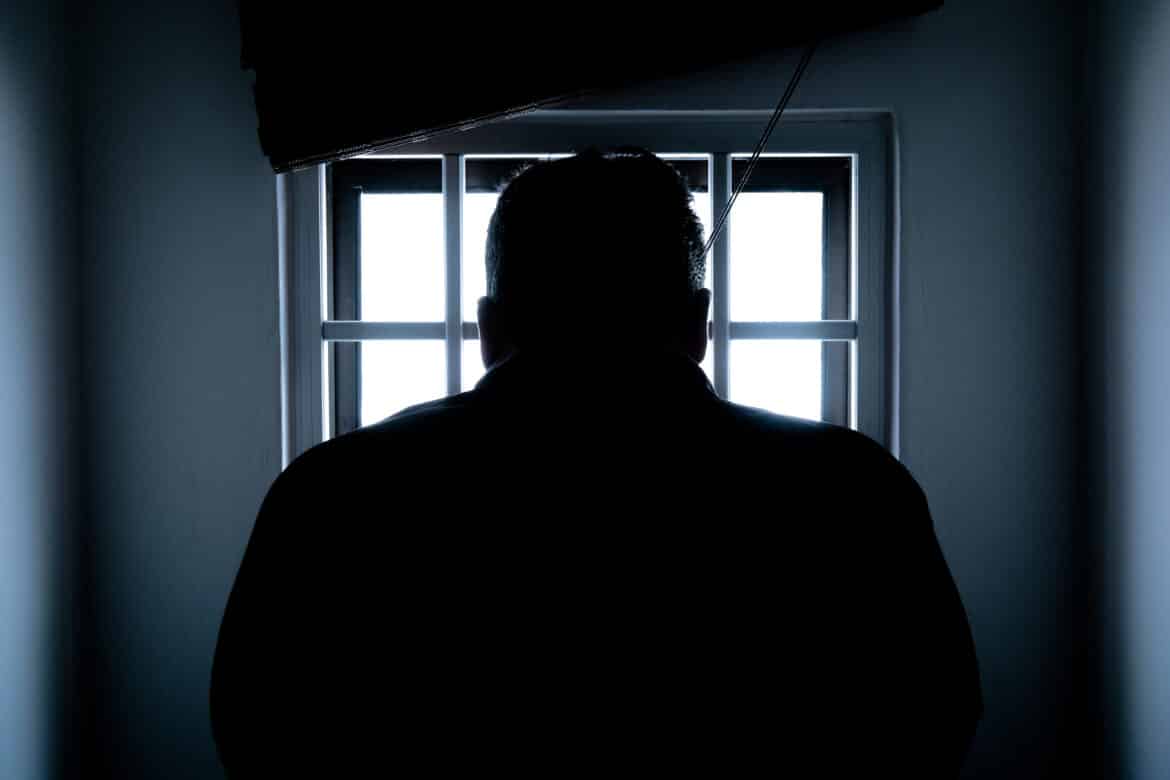 rear-view-of-a-silhouette-man-in-window-stockpack-pexels Rear view of a silhouette man in window