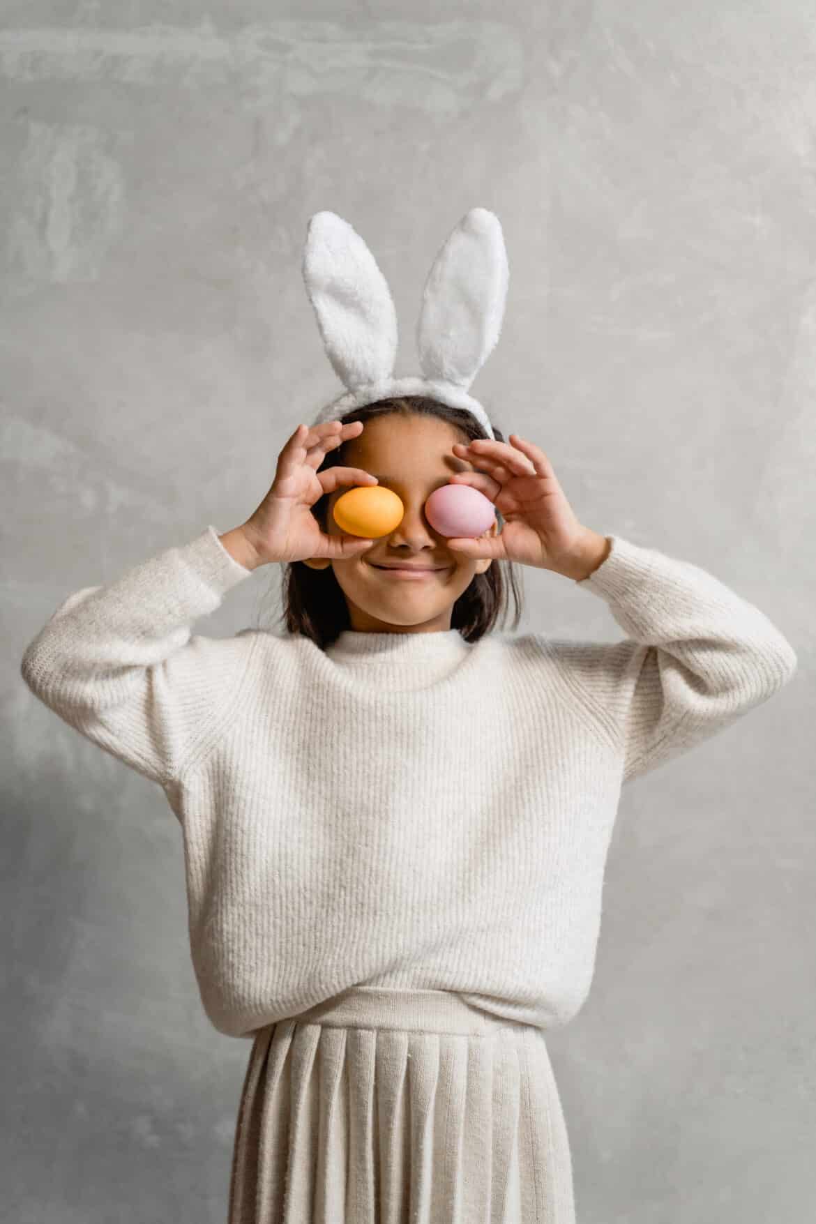 girl-wearing-easter-bunny-headwear-covering-her-eyes-with-easter-eggs-stockpack-pexels Girl wearing easter bunny headwear covering her eyes with easter eggs