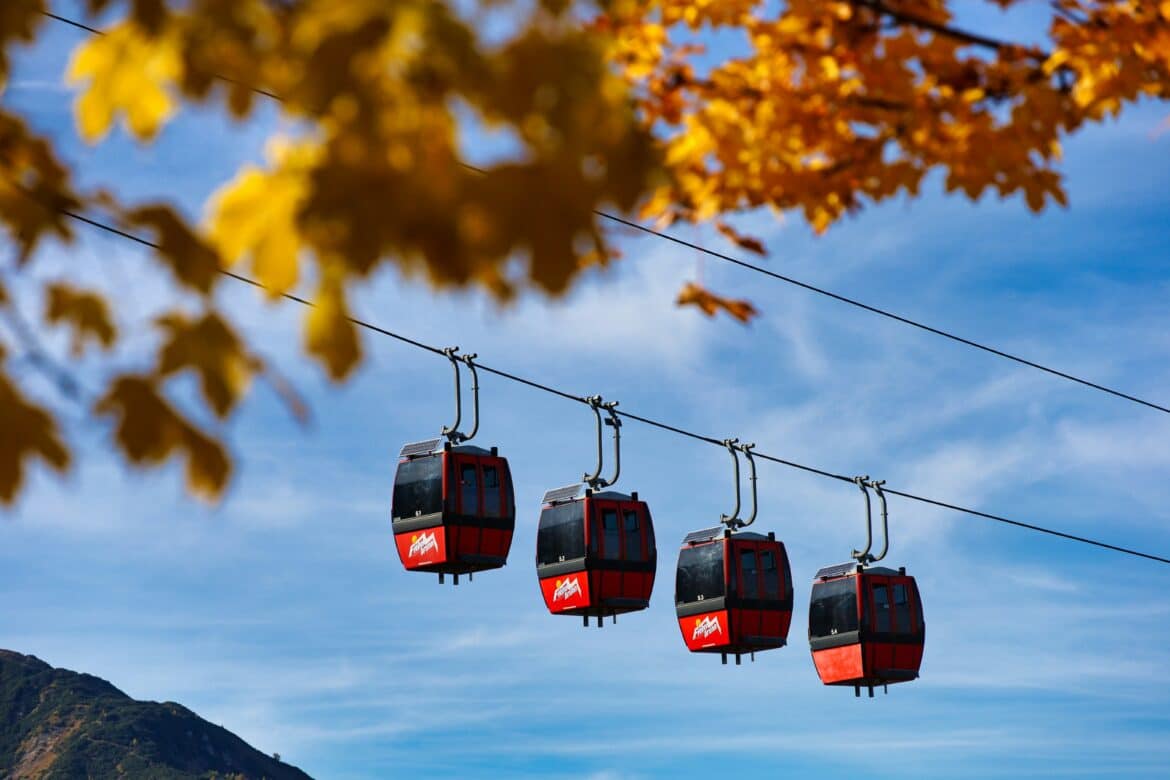 a-group-of-red-and-black-gondolas-hanging-from-a-wire-stockpack-unsplash a group of red and black gondolas hanging from a wire