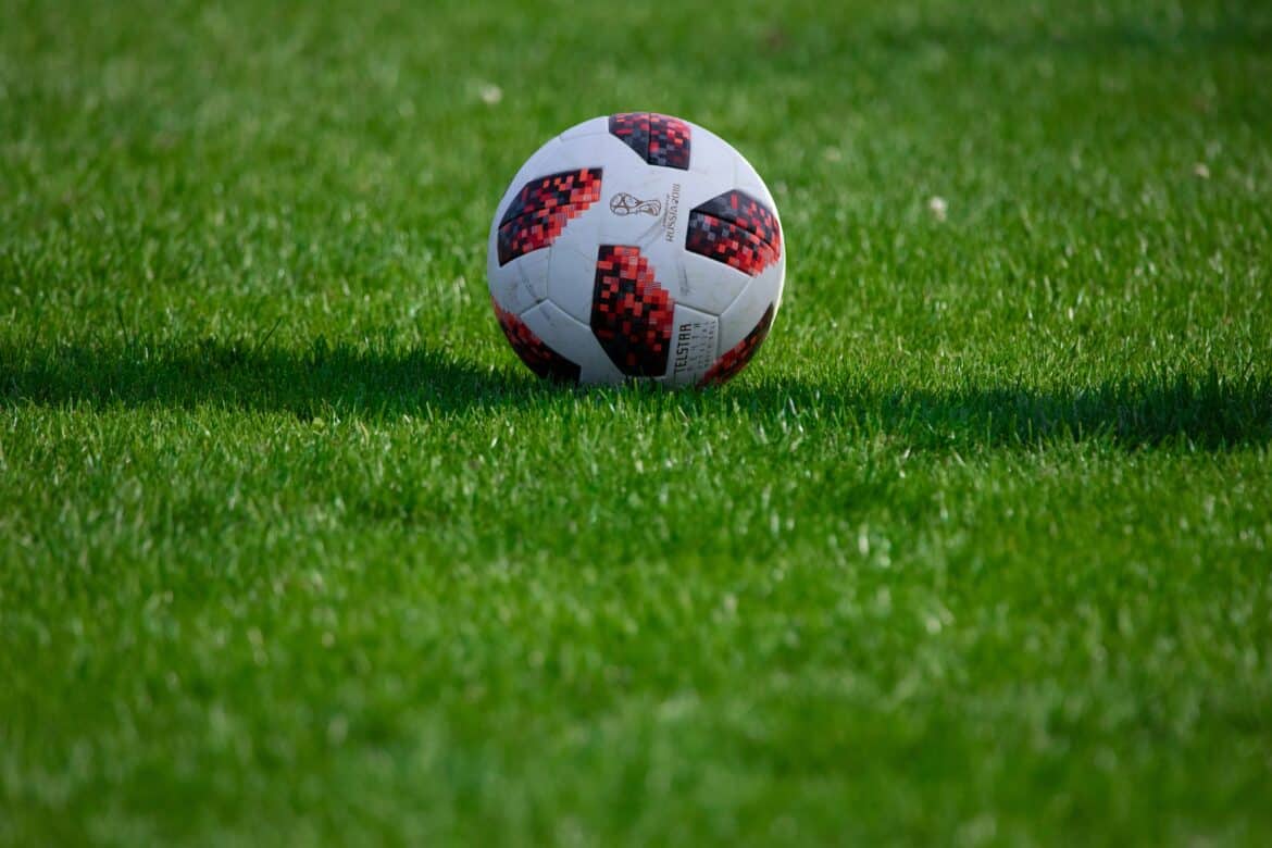 white-and-red-soccer-ball-on-green-grass-field-during-daytime-stockpack-unsplash