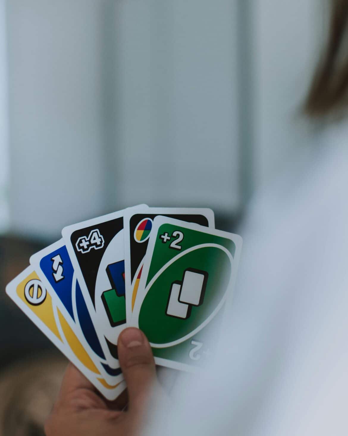 Person holding uno cards